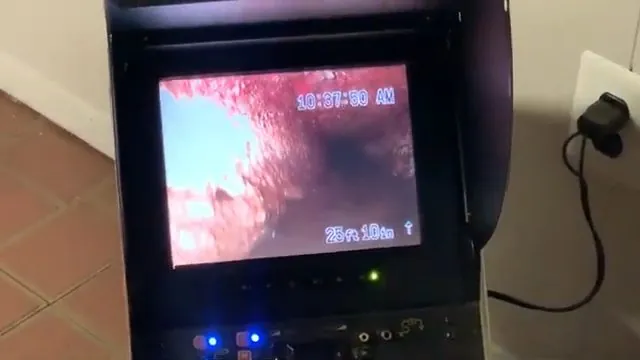 Camera inspection monitor displaying the inside of a pipe with a distance counter on screen.